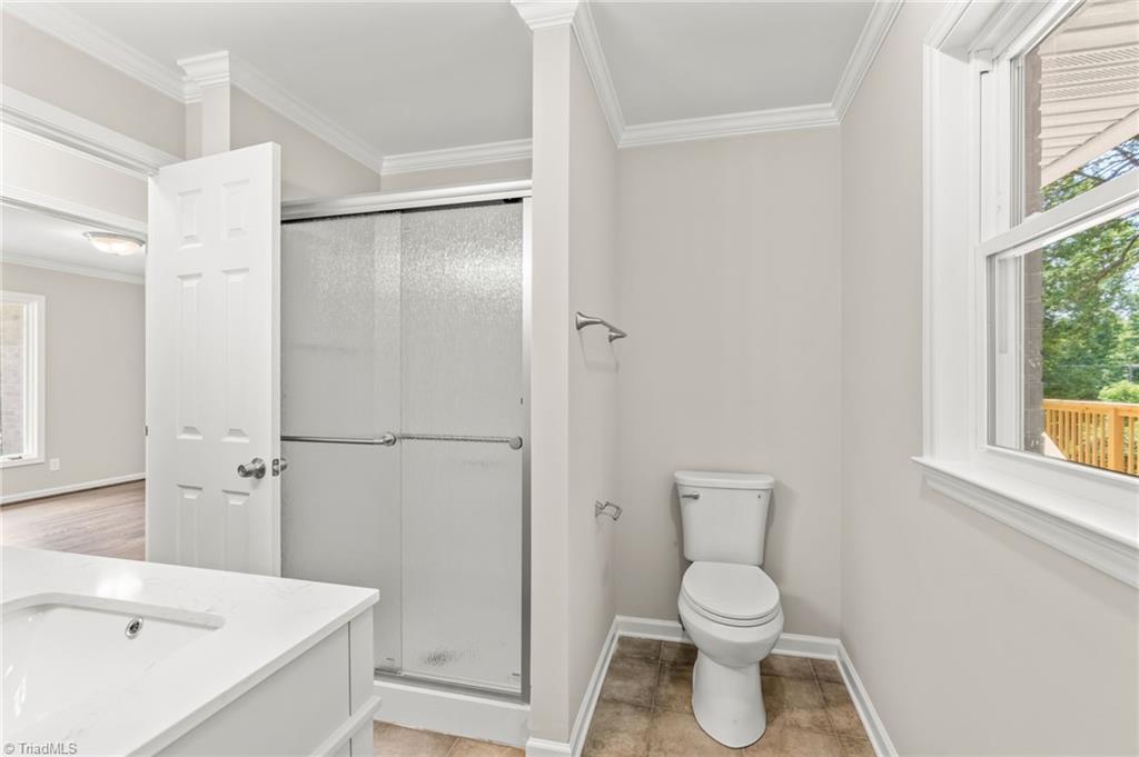 5902 Siler Road Greensboro, NC 27406 - Photo 32 of 49 Hall bathroom that's been completly remodeled with new floor, toilet, energy-efficient window, and double vanity.
