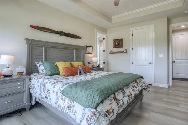 a bedroom with a bed and a night stand