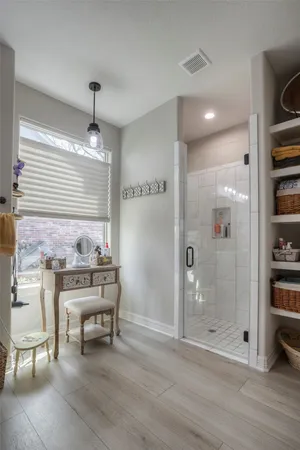 a view of a hallway with wooden floor and furniture