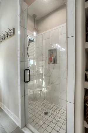 a bathroom with a glass shower door