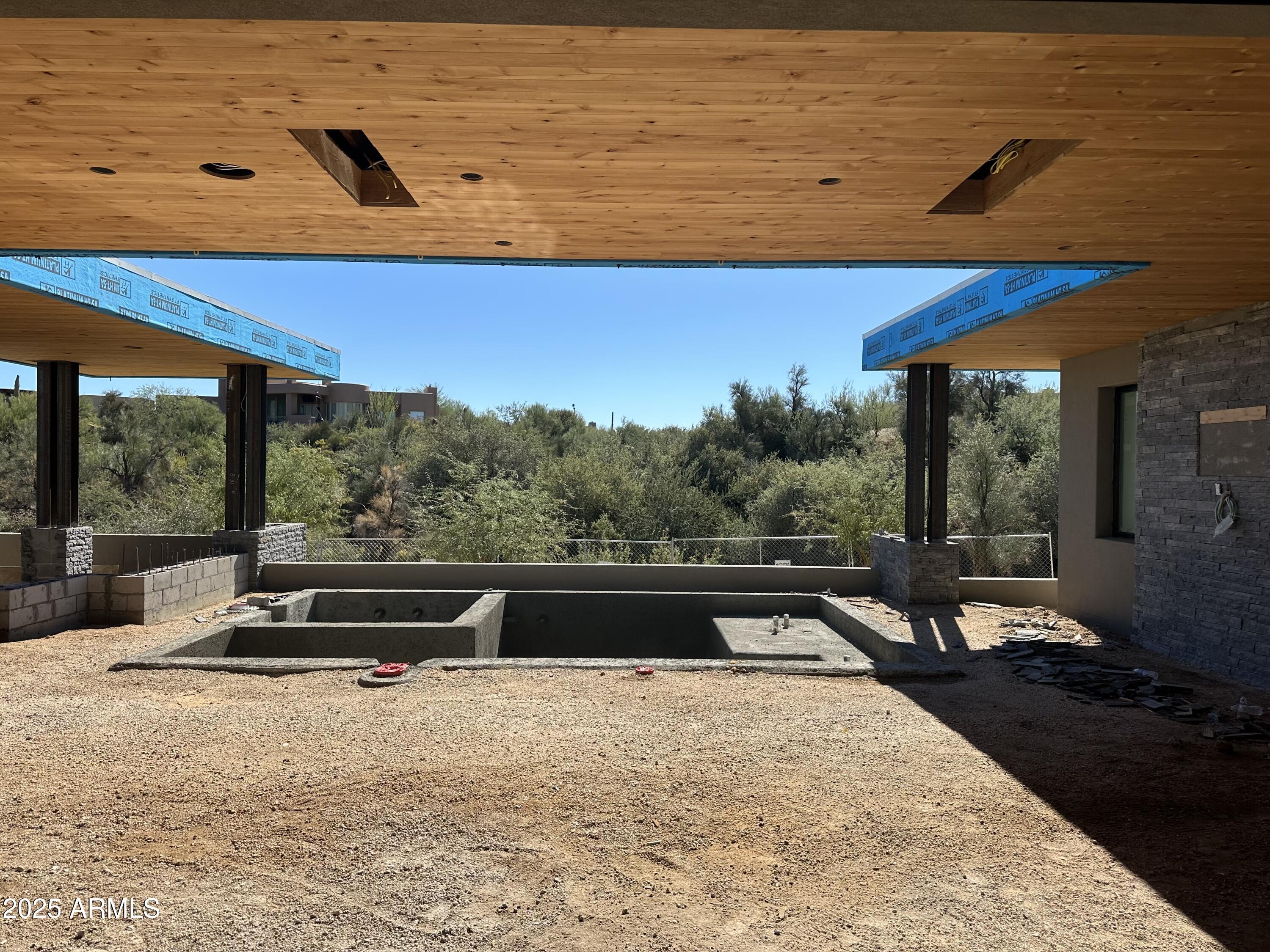 10023 East Filaree Lane Scottsdale, AZ 85262 - Photo 24 of 41 a view of a swimming pool with a table and chairs in the patio
