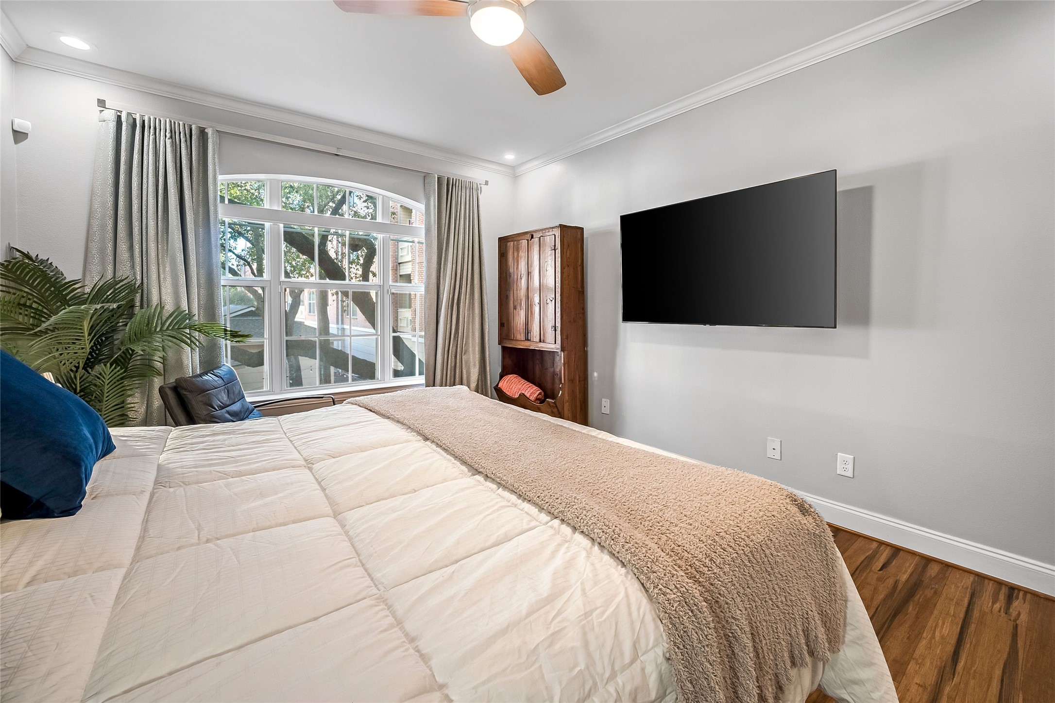 2111 Welch Street, Unit A113 Houston, TX 77019 - Photo 12 of 30 Primary Bedroom has Remote Controlled Black-Out Shade + Lovely Neutral Drapes