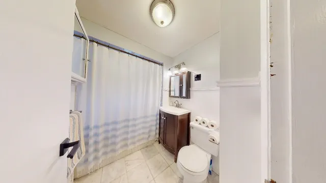 a bathroom with a toilet sink and shower