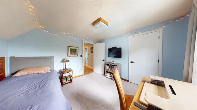 a bedroom with furniture and a flat screen tv