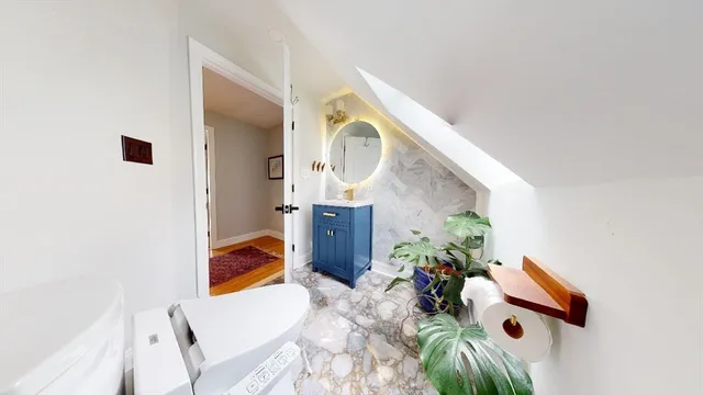 a view of living room with furniture and a potted plant