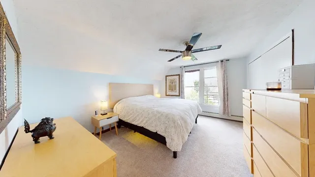 a spacious bedroom with a bed and window