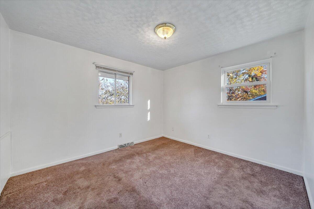 725 Ramada Road Vinton, VA 24179 - Photo 22 of 38 an empty room with a painting on the wall