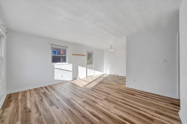 a view of wooden floor and windows in a room