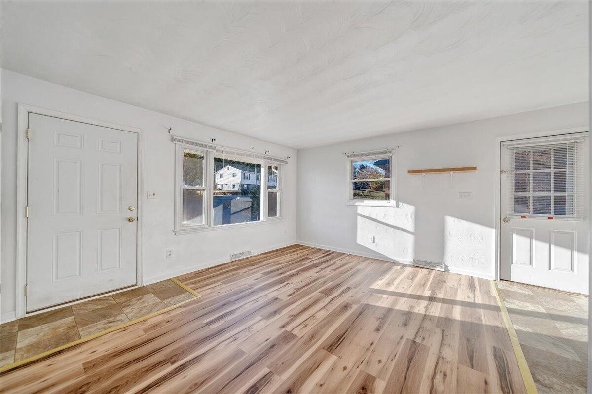 725 Ramada Road Vinton, VA 24179 - Photo 8 of 38 a big room with wooden floor and windows