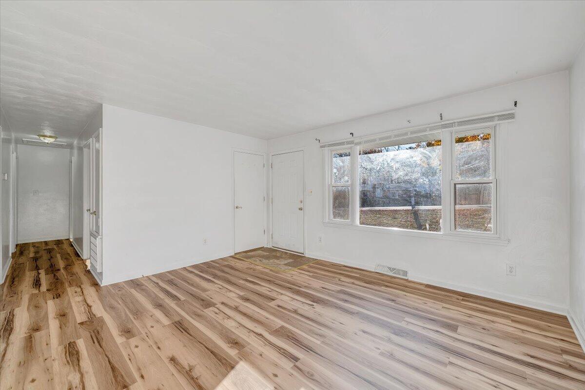 725 Ramada Road Vinton, VA 24179 - Photo 9 of 38 a view of empty room with wooden floor and fan