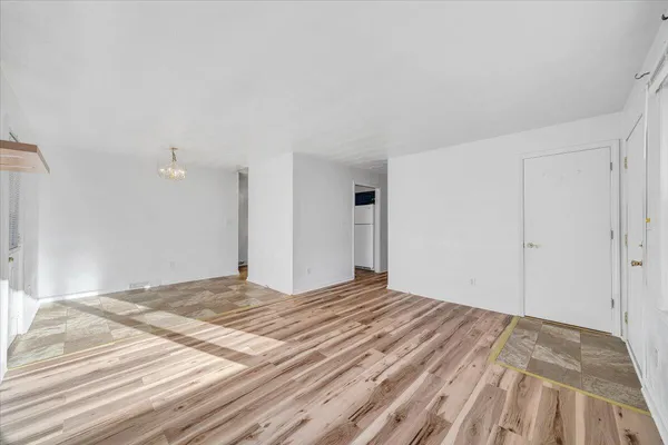 a bedroom with a bed and a wooden floor