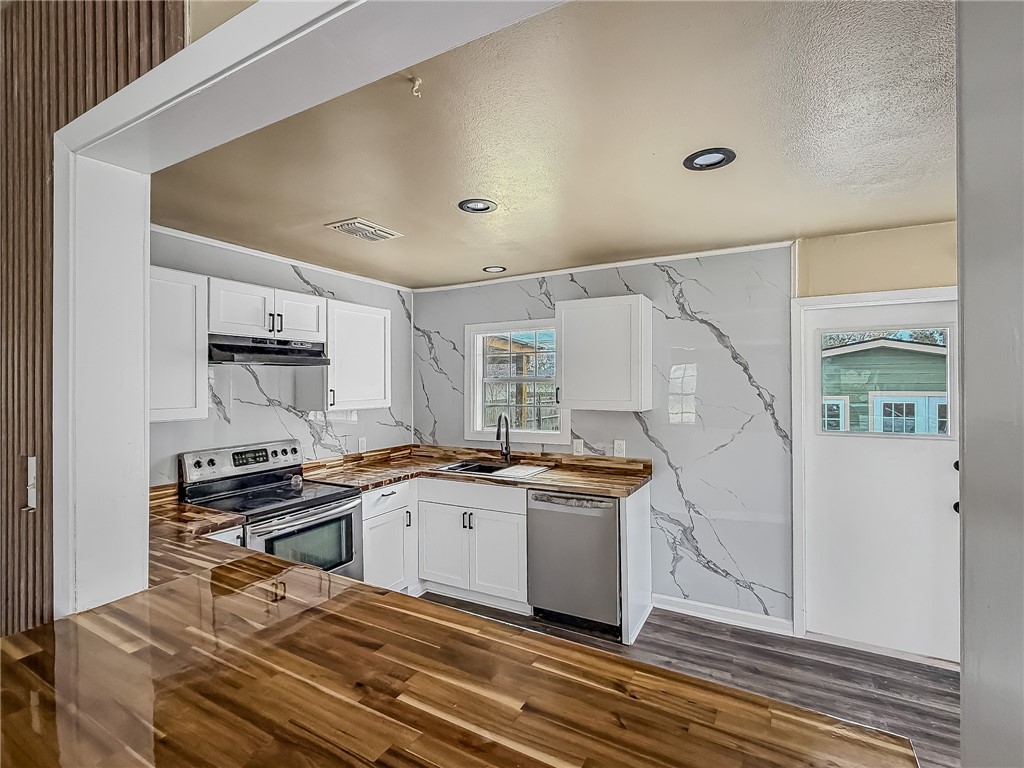 3437 Austin Street Corpus Christi, TX 78411 - Photo 11 of 35 a kitchen with stainless steel appliances granite countertop a sink stove and refrigerator