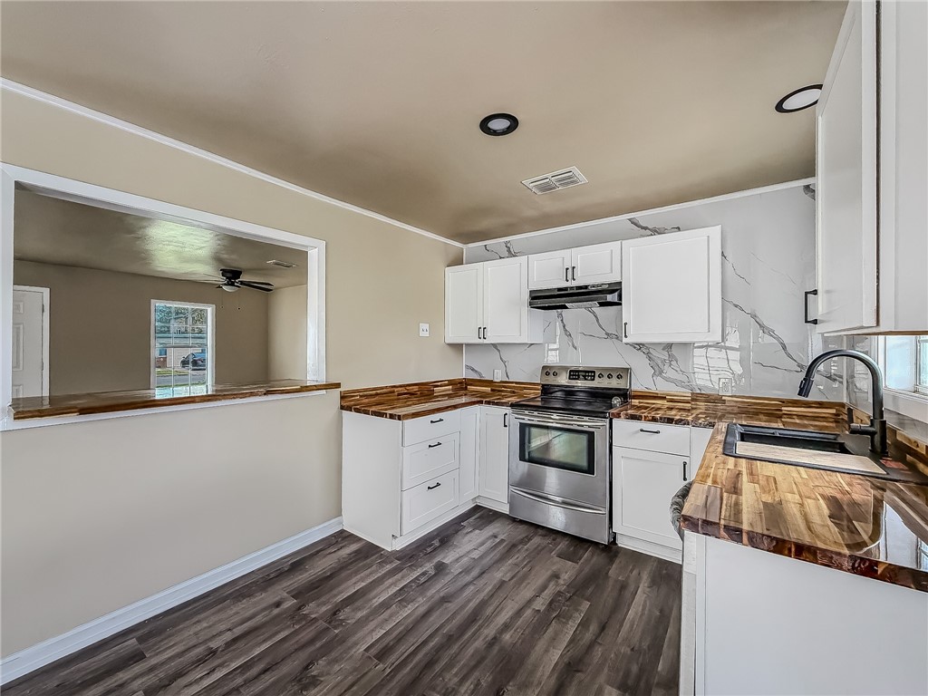 3437 Austin Street Corpus Christi, TX 78411 - Photo 12 of 35 a kitchen with granite countertop a stove top oven sink and cabinets