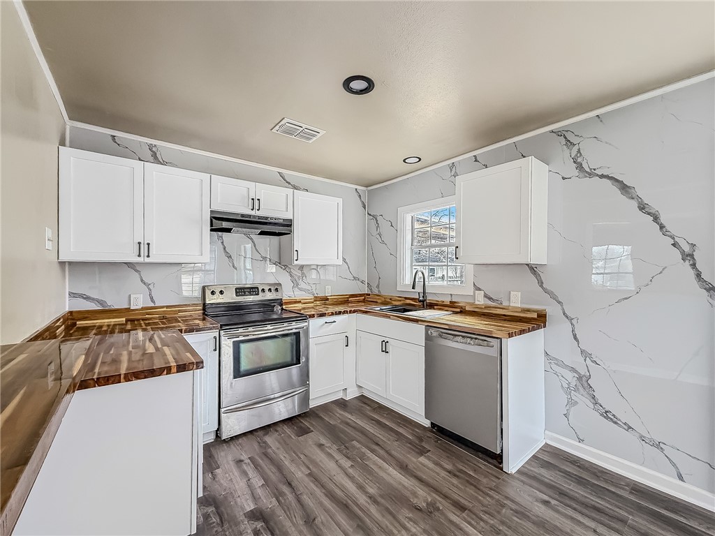 3437 Austin Street Corpus Christi, TX 78411 - Photo 13 of 35 a kitchen with a sink stove and white cabinets