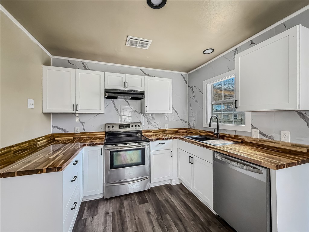 3437 Austin Street Corpus Christi, TX 78411 - Photo 14 of 35 a kitchen with stainless steel appliances granite countertop a sink stove and cabinets