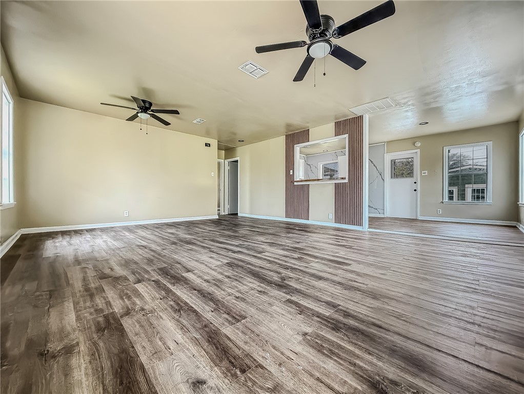 3437 Austin Street Corpus Christi, TX 78411 - Photo 5 of 35 a view of a livingroom with a ceiling fan and wooden floor