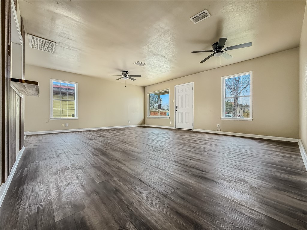 3437 Austin Street Corpus Christi, TX 78411 - Photo 7 of 35 a view of an empty room with a window and wooden floor