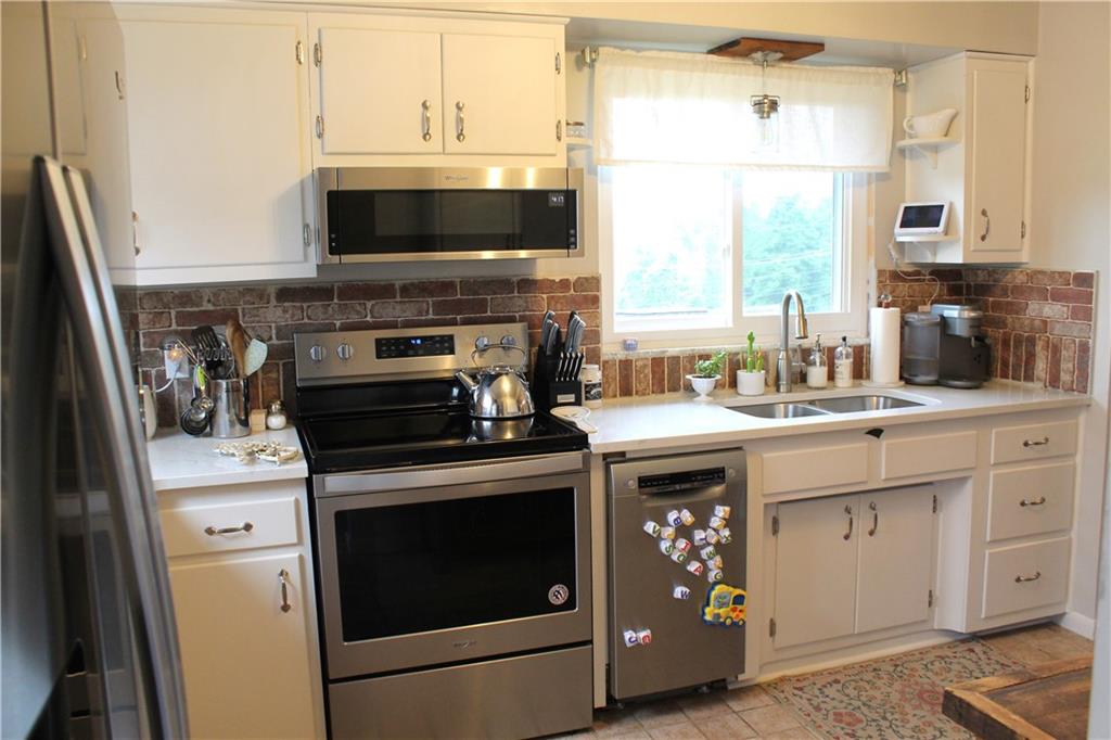 1330 Amity Ridge Road Washington, PA 15301 - Photo 3 of 19 a kitchen with stainless steel appliances a stove a sink and a microwave