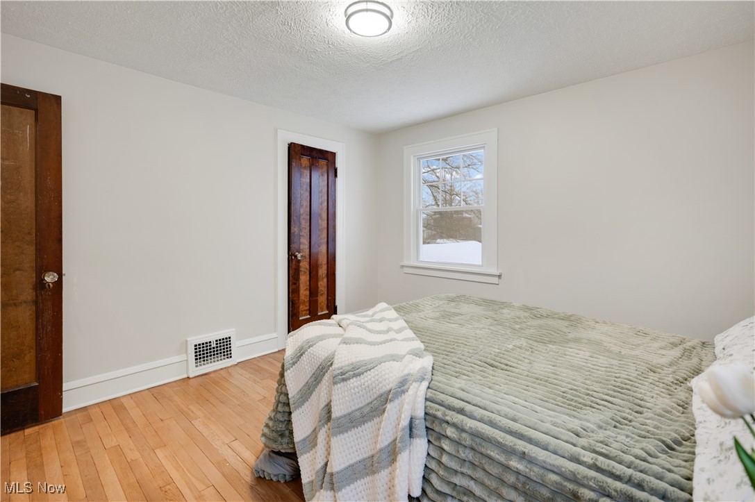 2016 Rossmoor Road Cleveland Heights, OH 44118 - Photo 26 of 46 Bedroom featuring a textured ceiling and wood-type flooring