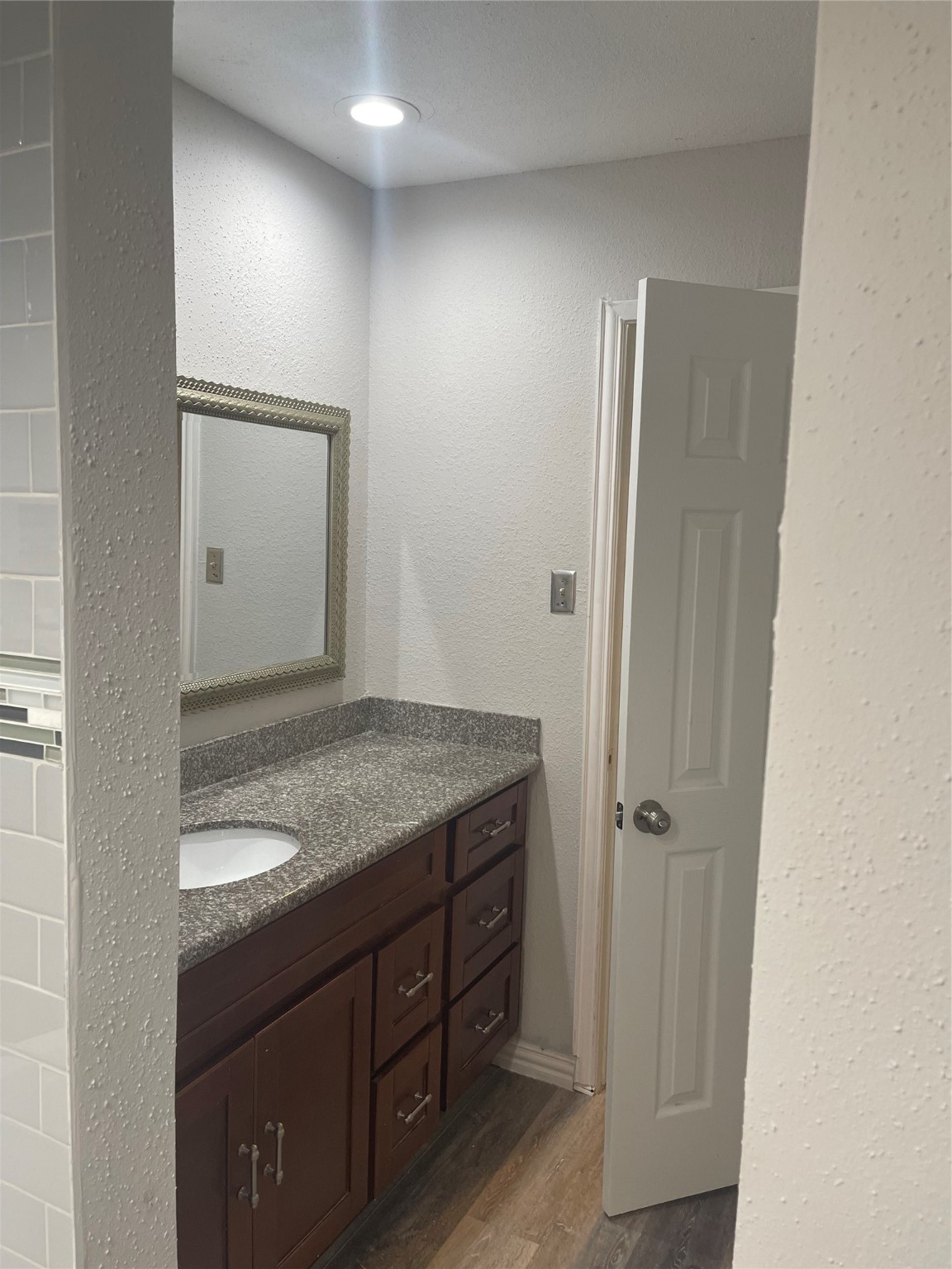 10912 Gulf Freeway, Unit 73 Houston, TX 77075 - Photo 12 of 27 a bathroom with a granite countertop sink and a mirror