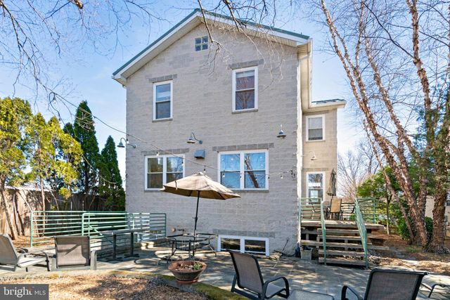 a kitchen with stainless steel appliances granite countertop a sink a counter space wooden cabinets and counter top space