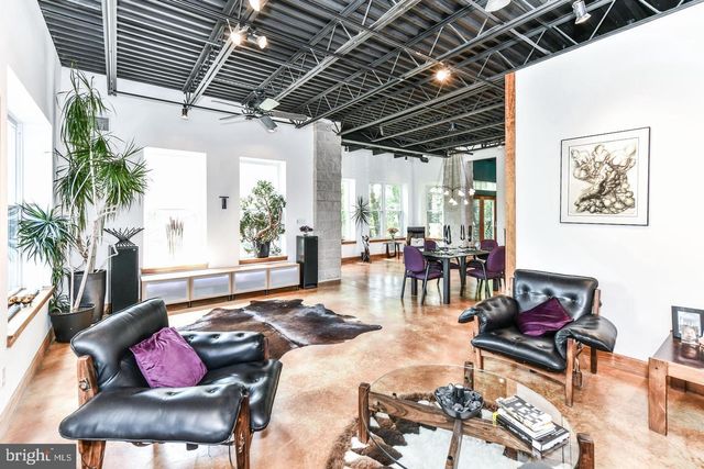 a bedroom with a bed next to a window with the outer view