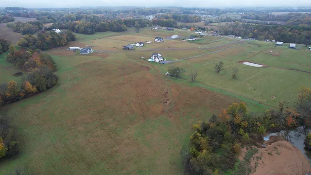 an aerial view of a houses with yard