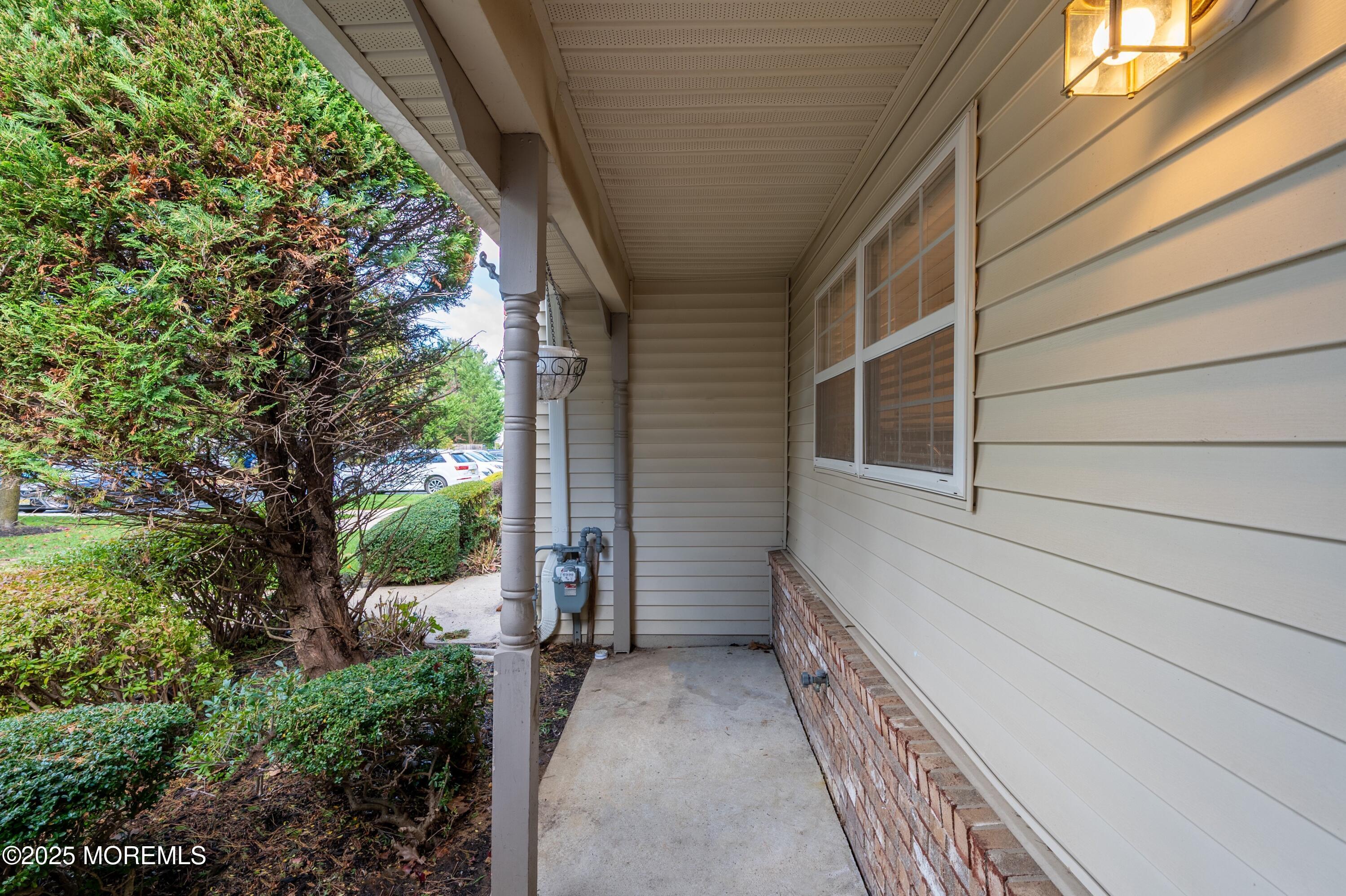 9 Ambrose Lane, Unit 141 Holmdel, NJ 07733 - Photo 12 of 50 a view of a pathway of a house with wooden fence