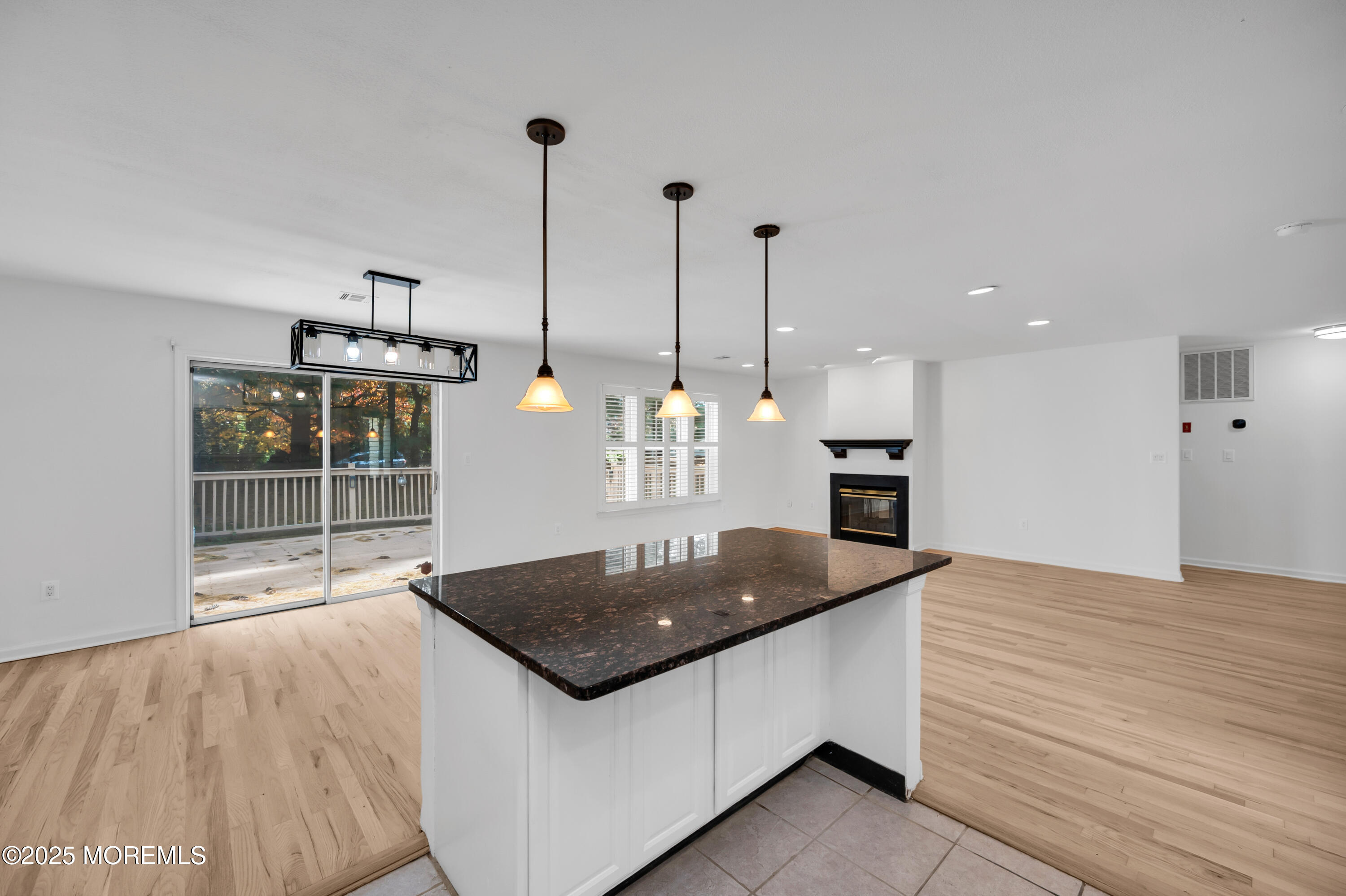 9 Ambrose Lane, Unit 141 Holmdel, NJ 07733 - Photo 18 of 50 a kitchen with stainless steel appliances granite countertop a sink a oven and a wooden floors