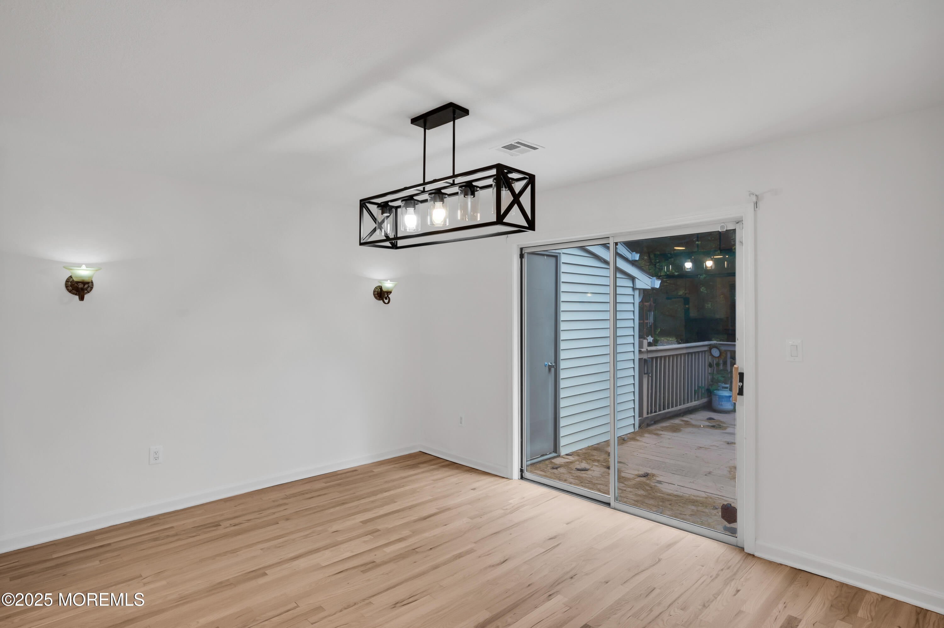 9 Ambrose Lane, Unit 141 Holmdel, NJ 07733 - Photo 20 of 50 a view of a room with wooden floor and white walls