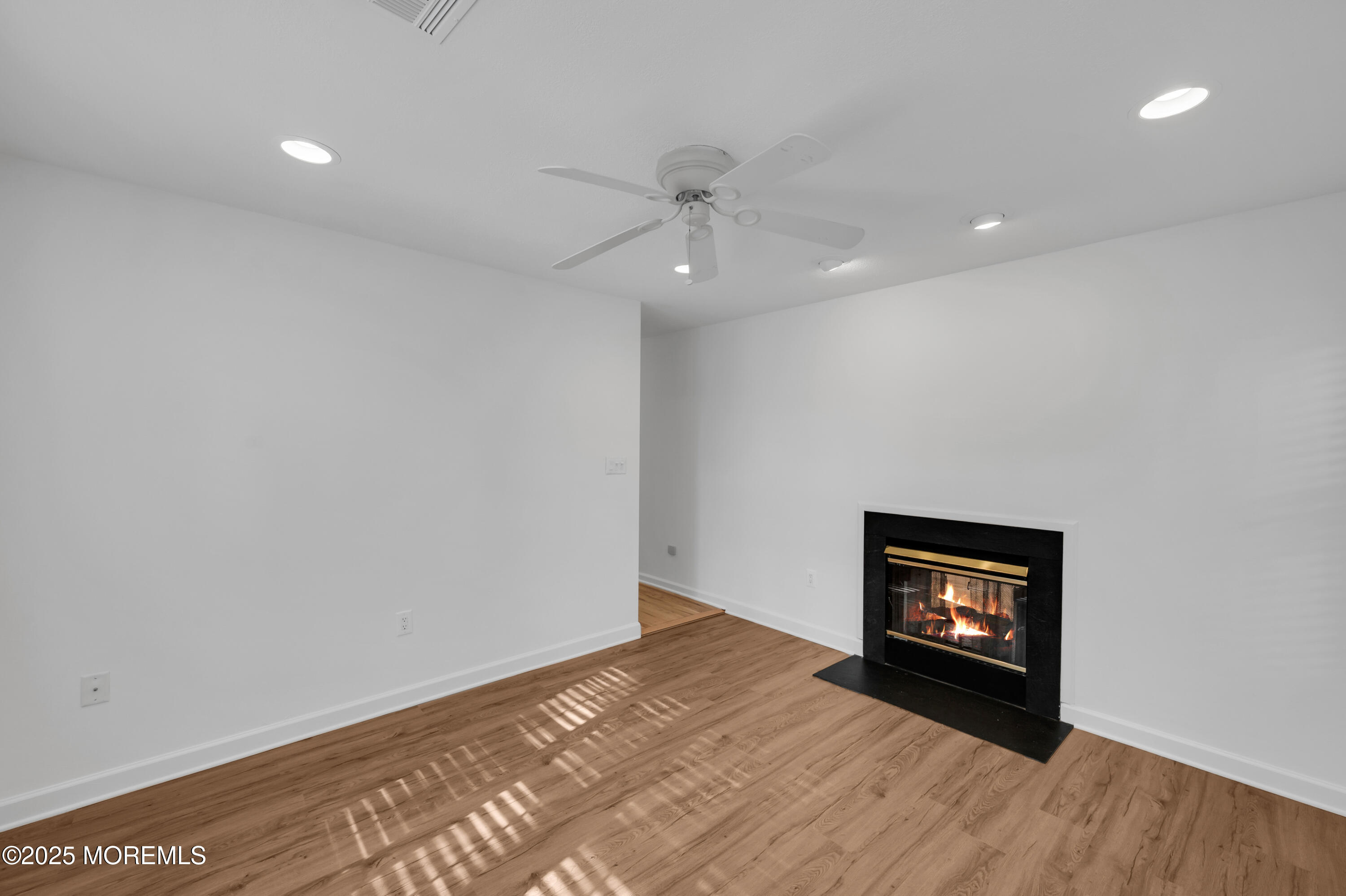 9 Ambrose Lane, Unit 141 Holmdel, NJ 07733 - Photo 26 of 50 wooden floor in an empty room with a window