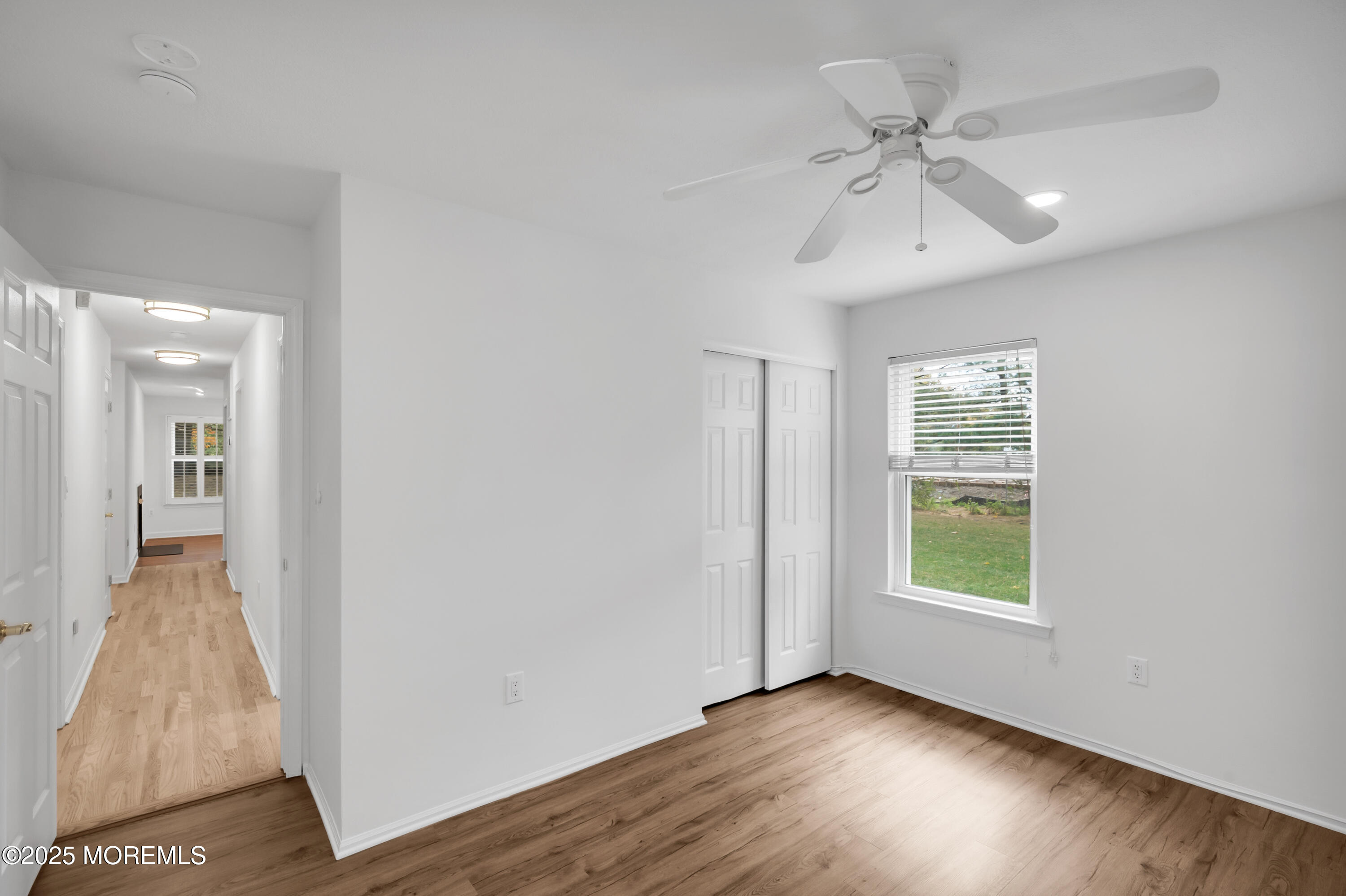 9 Ambrose Lane, Unit 141 Holmdel, NJ 07733 - Photo 32 of 50 a view of an empty room with wooden floor and a window