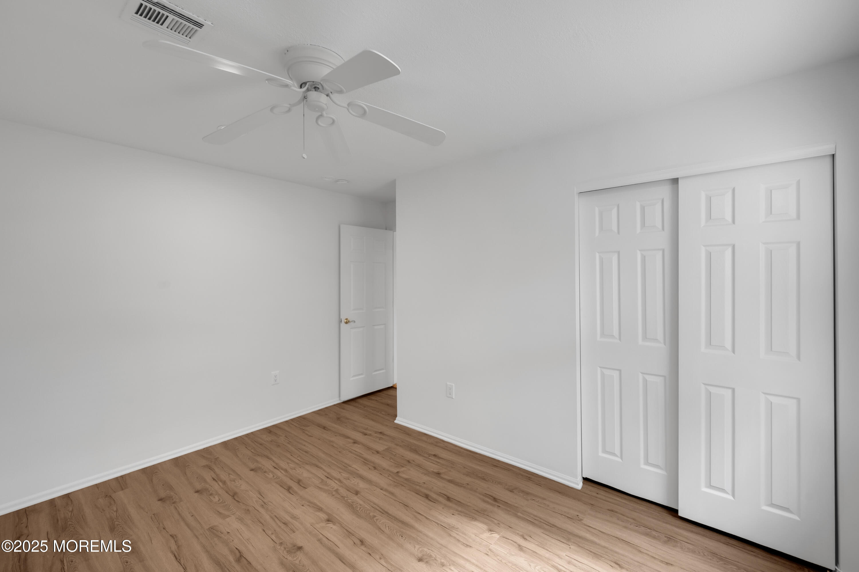 9 Ambrose Lane, Unit 141 Holmdel, NJ 07733 - Photo 33 of 50 wooden floor in an empty room