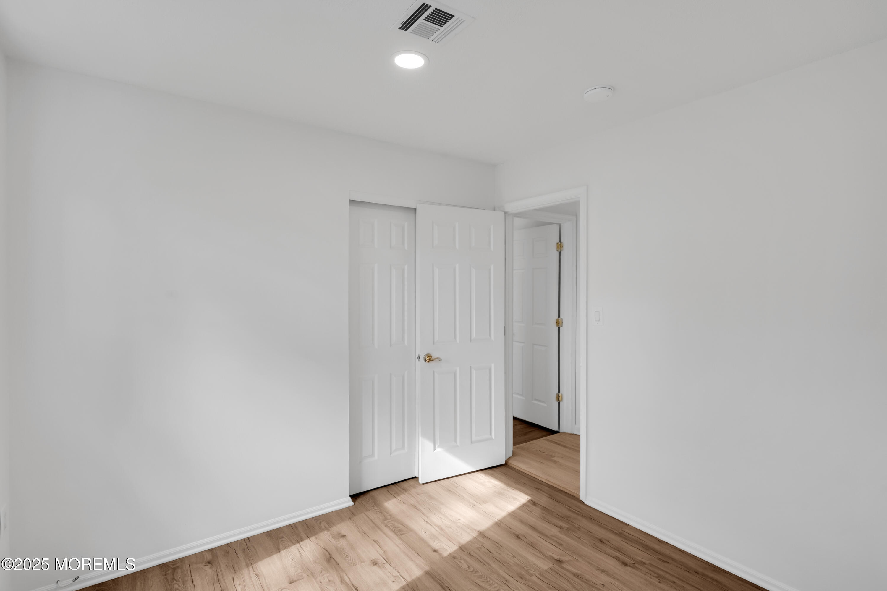 9 Ambrose Lane, Unit 141 Holmdel, NJ 07733 - Photo 34 of 50 a view of an empty room and wooden floor