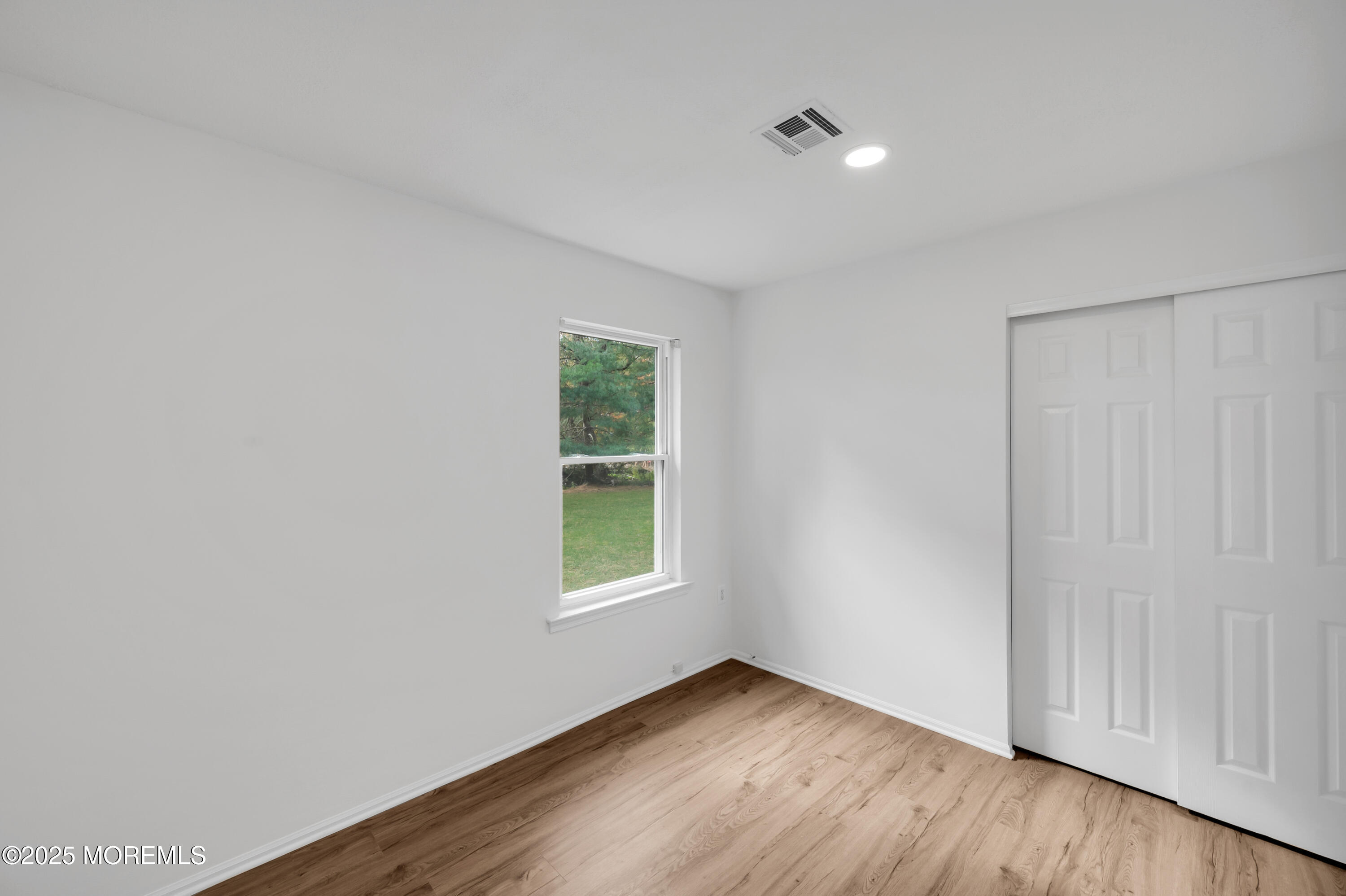 9 Ambrose Lane, Unit 141 Holmdel, NJ 07733 - Photo 35 of 50 an empty room with wooden floor and windows