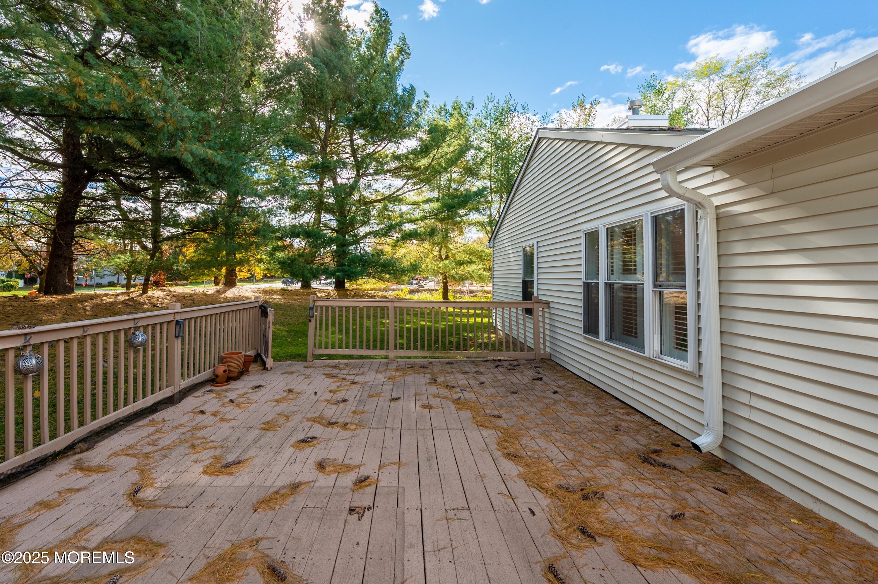9 Ambrose Lane, Unit 141 Holmdel, NJ 07733 - Photo 44 of 50 a view of a backyard with a deck