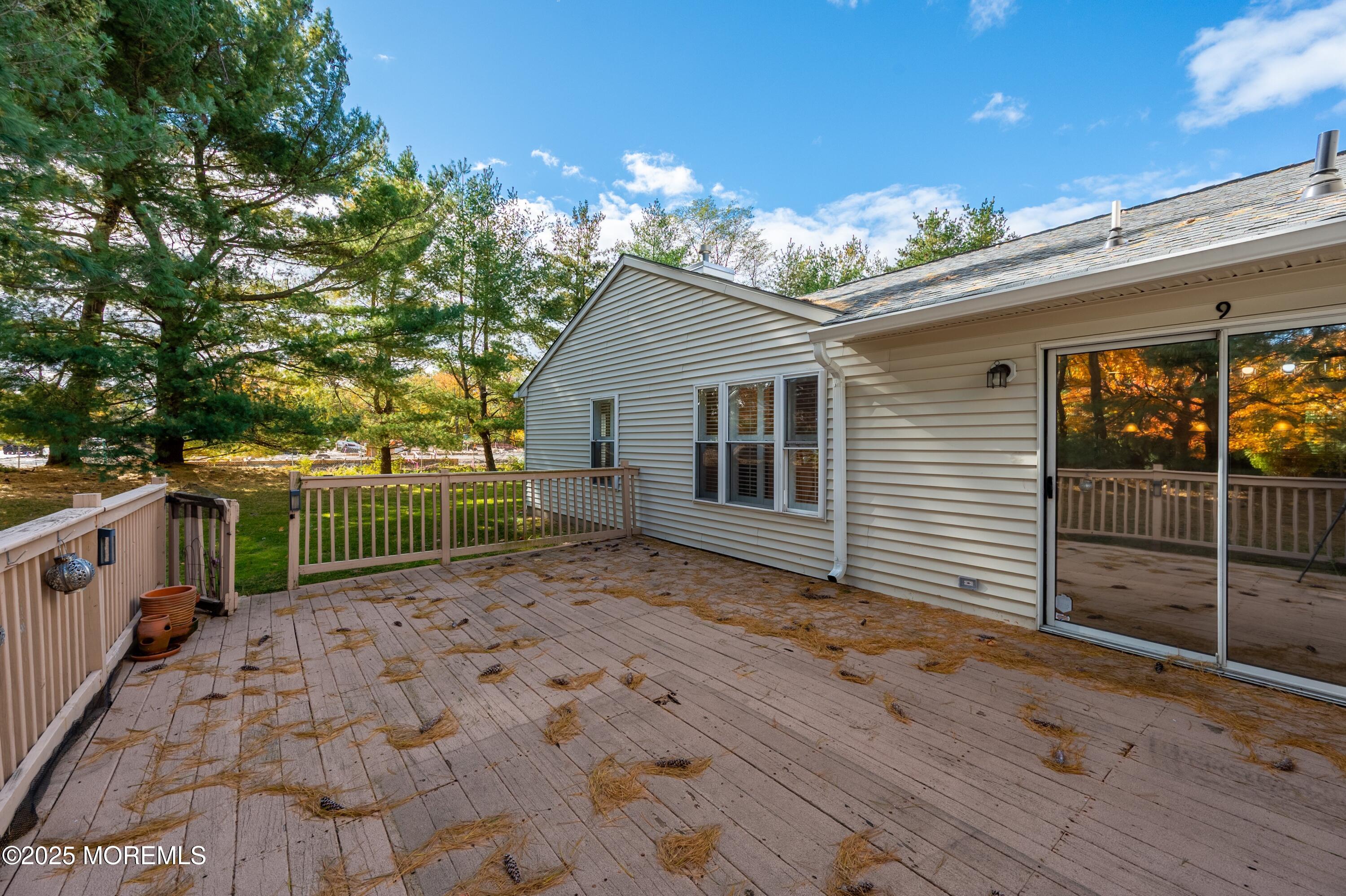 9 Ambrose Lane, Unit 141 Holmdel, NJ 07733 - Photo 46 of 50 a view of a backyard with a wooden fence