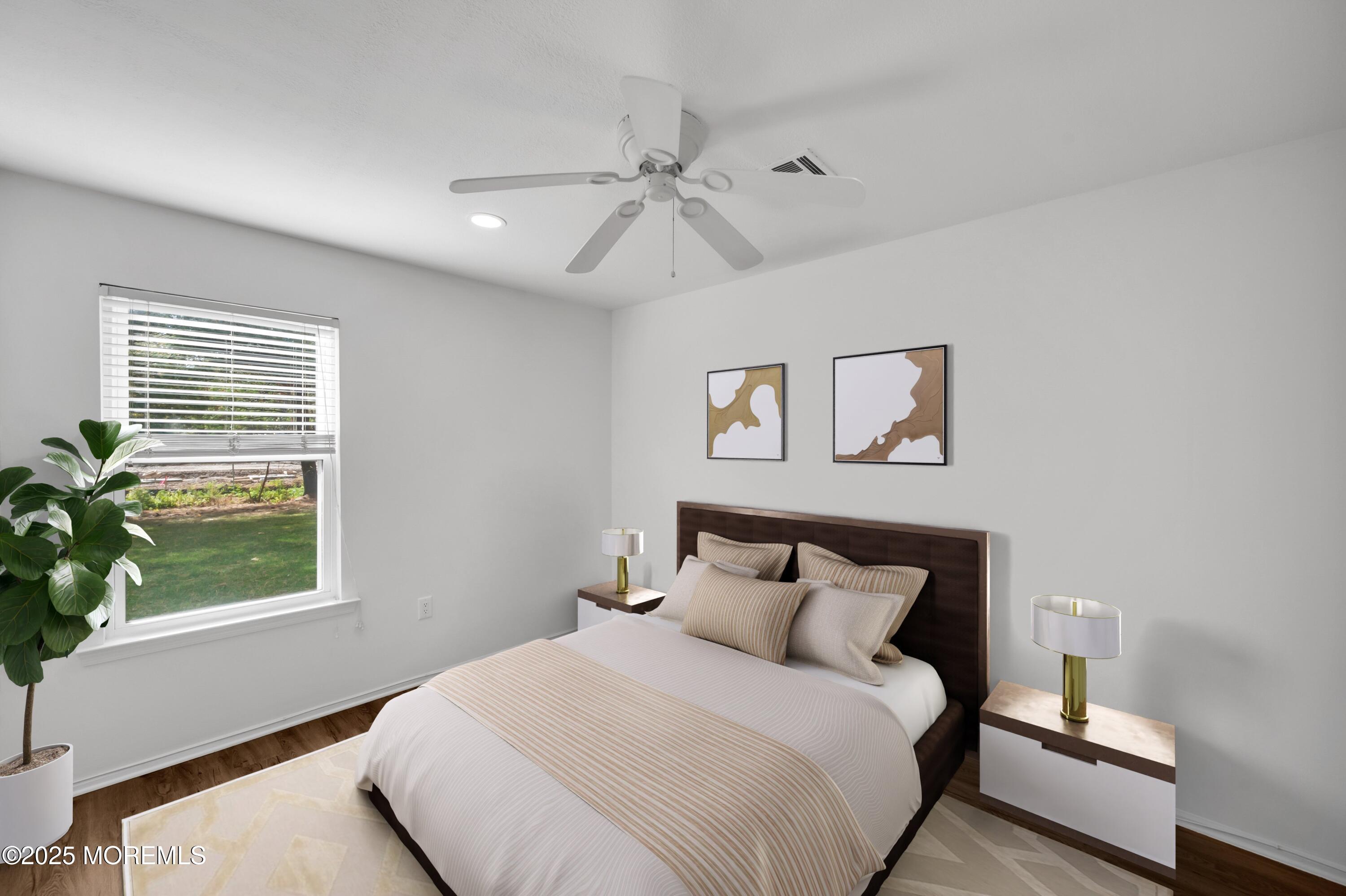 9 Ambrose Lane, Unit 141 Holmdel, NJ 07733 - Photo 6 of 50 a bedroom with a bed and a window