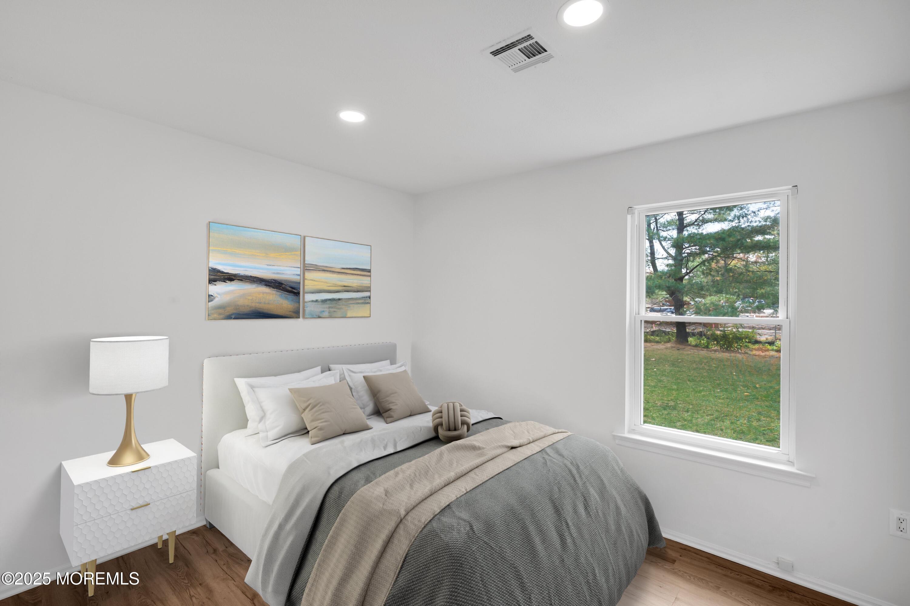 9 Ambrose Lane, Unit 141 Holmdel, NJ 07733 - Photo 7 of 50 a bedroom with a bed and a window