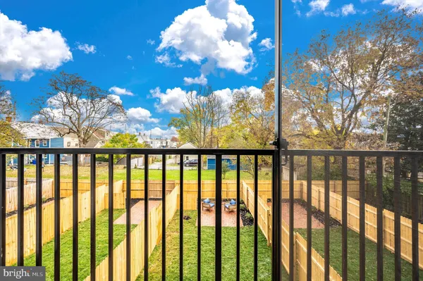 a view of a kitchen with stainless steel appliances a stove a sink dishwasher a dining table and chair with wooden floor