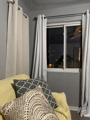 a bedroom with a bed and a night stand