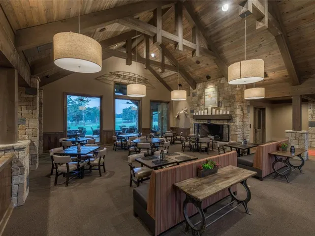 a living room with fireplace furniture and a large window