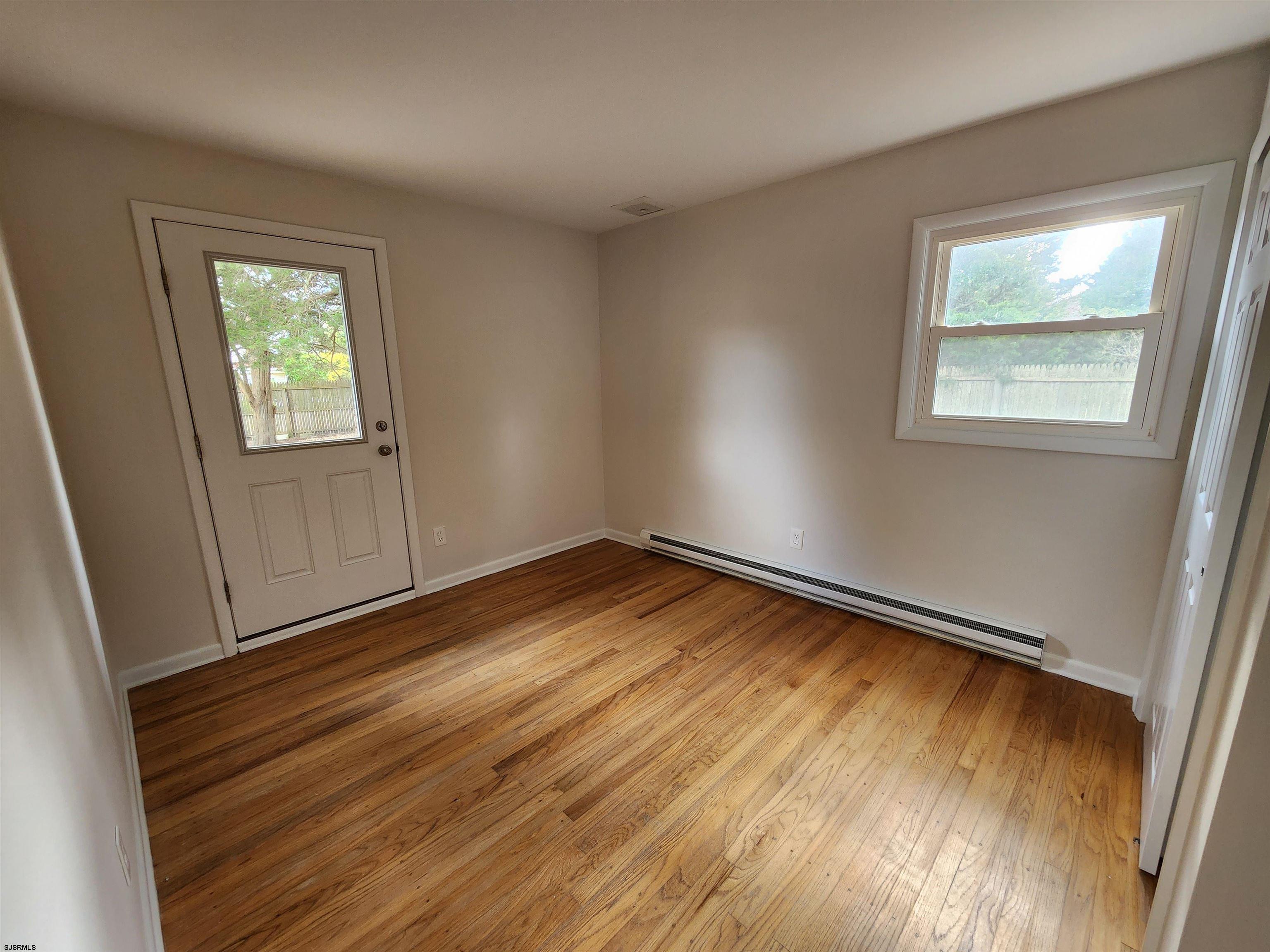 10 Point Pleasant Avenue Beesleys Point, NJ 08223 - Photo 11 of 16 a view of empty room with wooden floor and fan