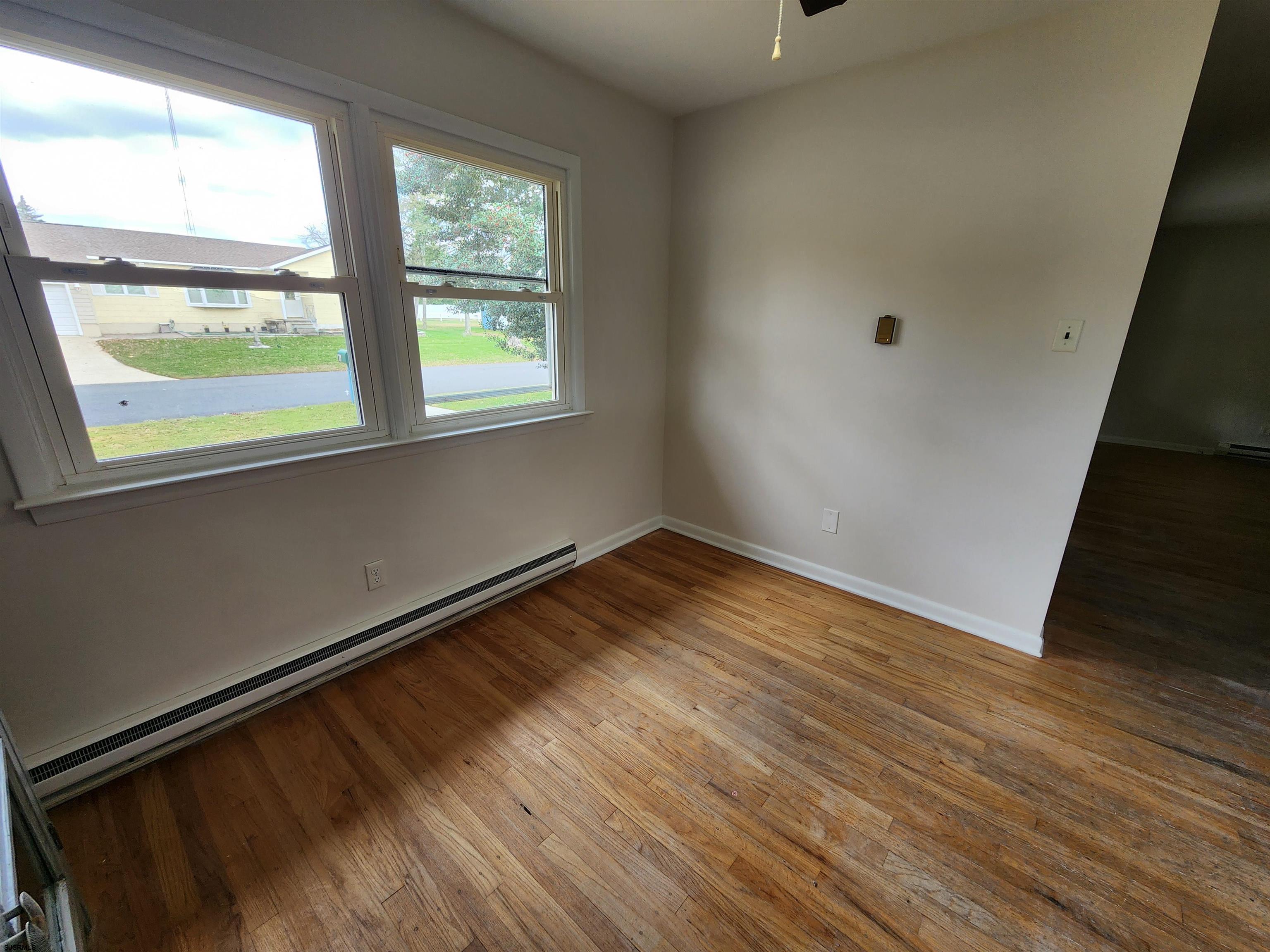 10 Point Pleasant Avenue Beesleys Point, NJ 08223 - Photo 7 of 16 an empty room with wooden floor and windows
