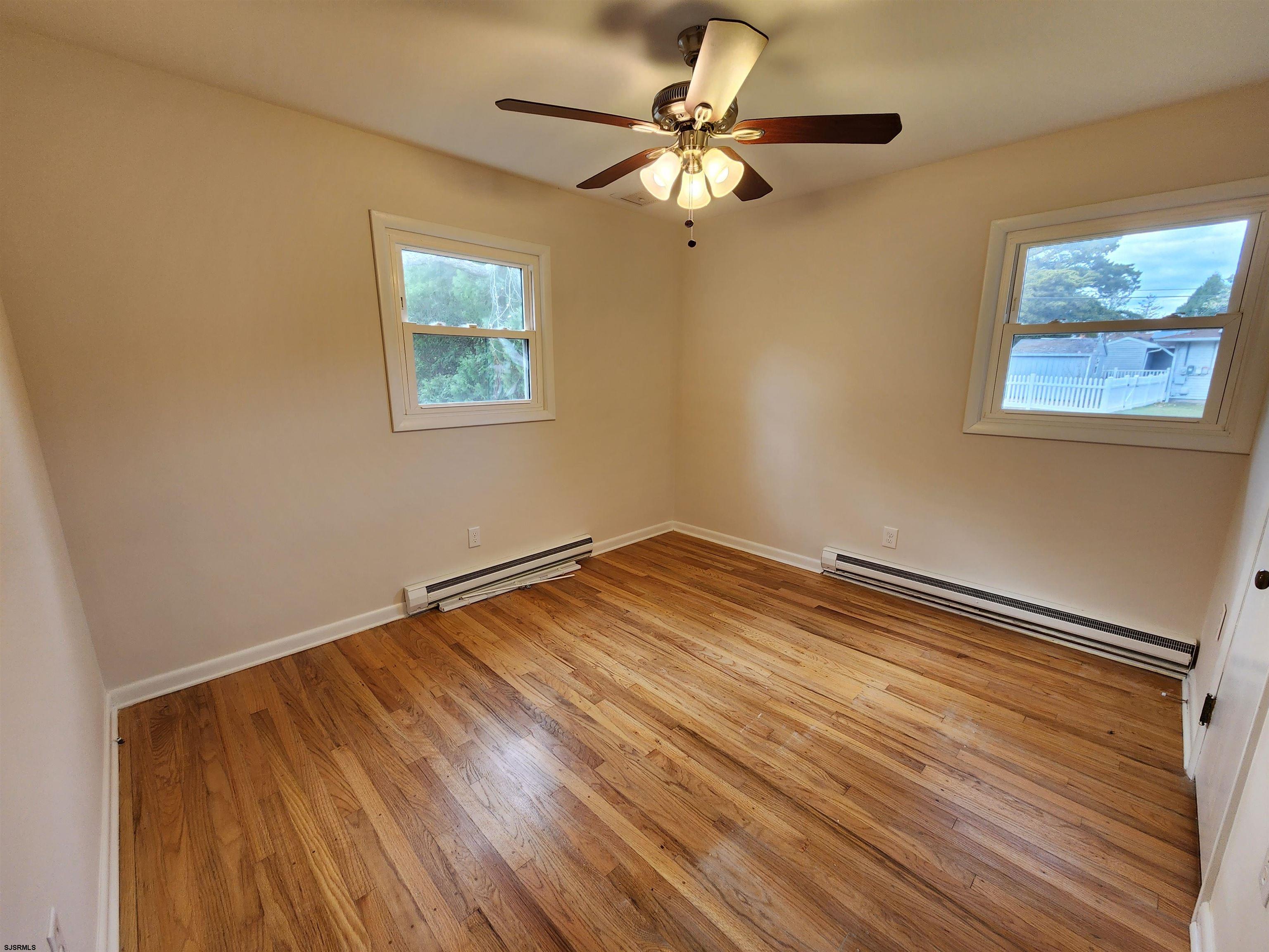 10 Point Pleasant Avenue Beesleys Point, NJ 08223 - Photo 8 of 16 a view of a room with wooden floor and a ceiling fan