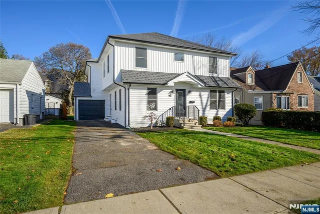 a front view of a house with a yard table and chairs