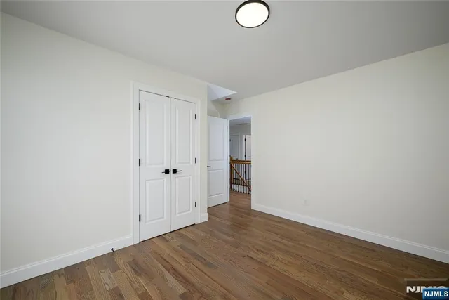 a view of an empty room and wooden floor