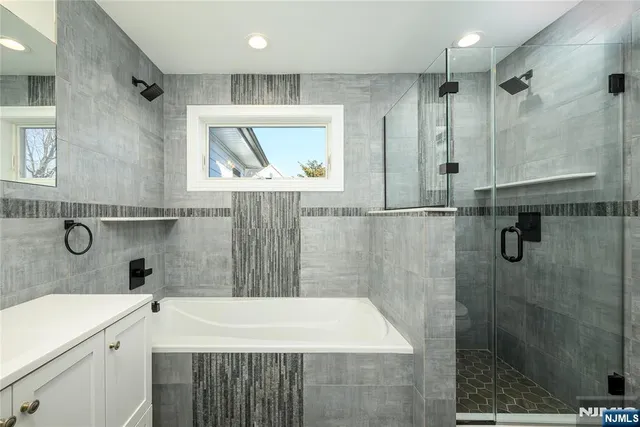 a bathroom with a sink a mirror and a shower