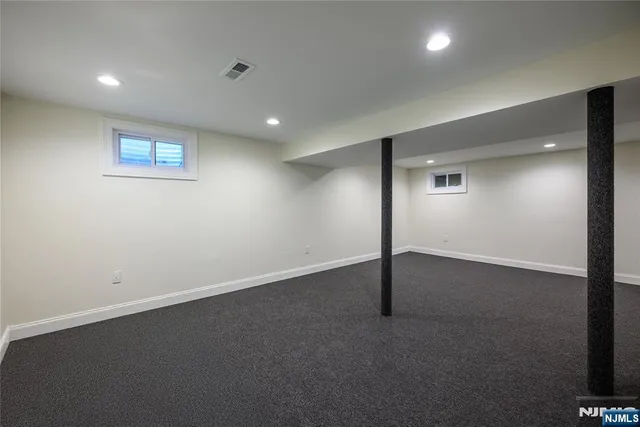 an empty room with a empty space and windows