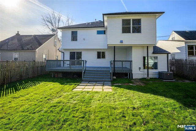 a view of a house with backyard and a garden